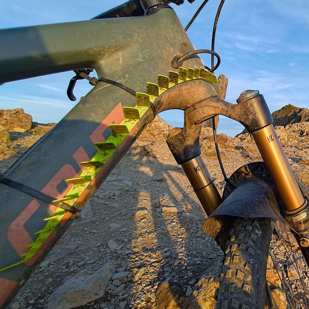 CombOver MTB mudguard in green on rocky mountain summit during golden hour